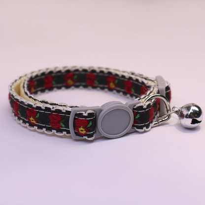 Black apple-pattern cat collar with gray buckle and bell