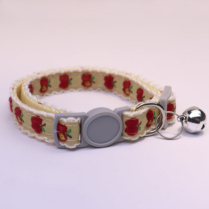 Yellow cat collar with red apple pattern, gray buckle and bell