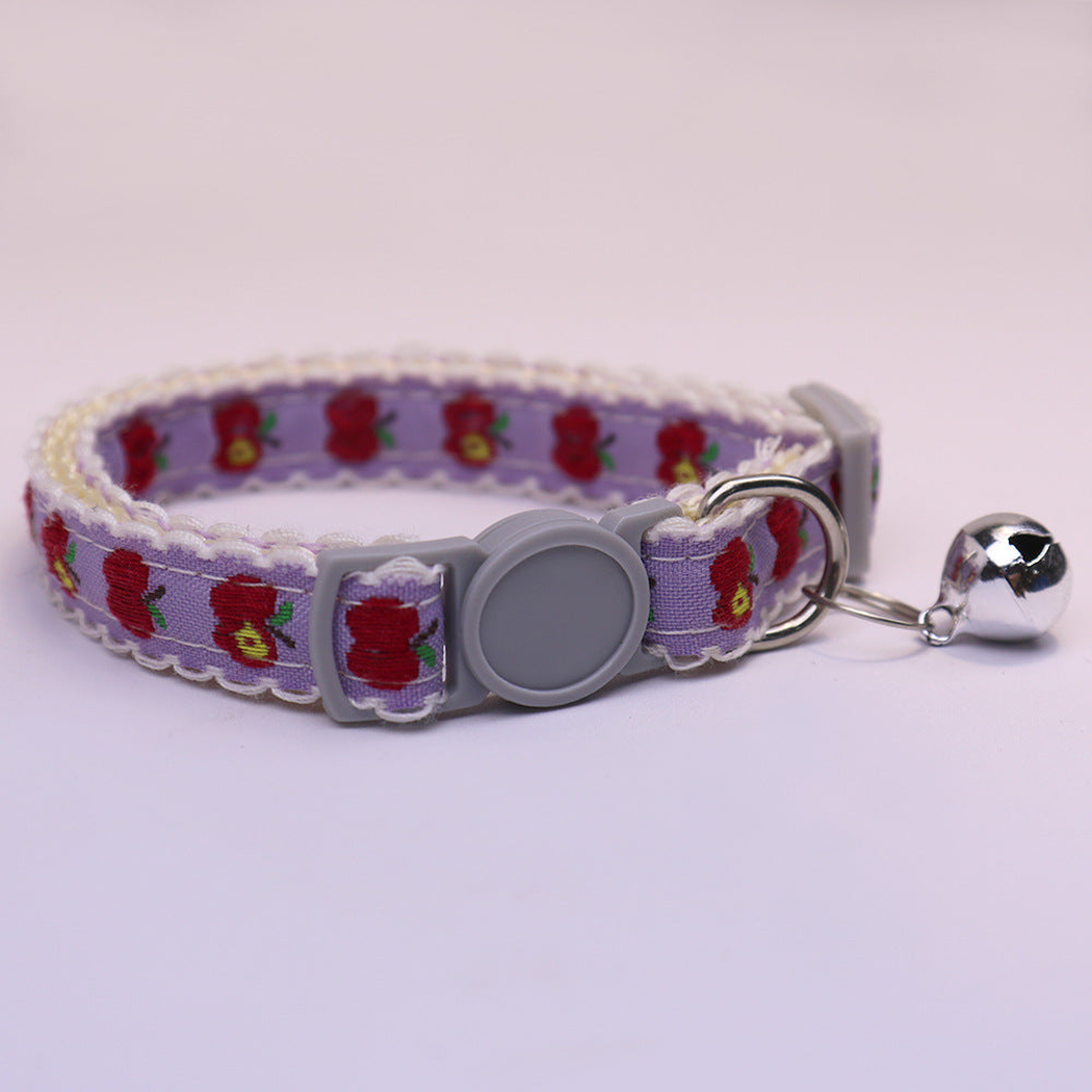 Purple cat collar with red apple pattern, gray buckle and bell