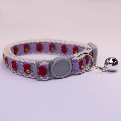 Purple cat collar with red apple pattern, gray buckle and bell