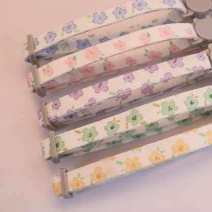 Close-up of the repeating floral patterns on five cat collar straps