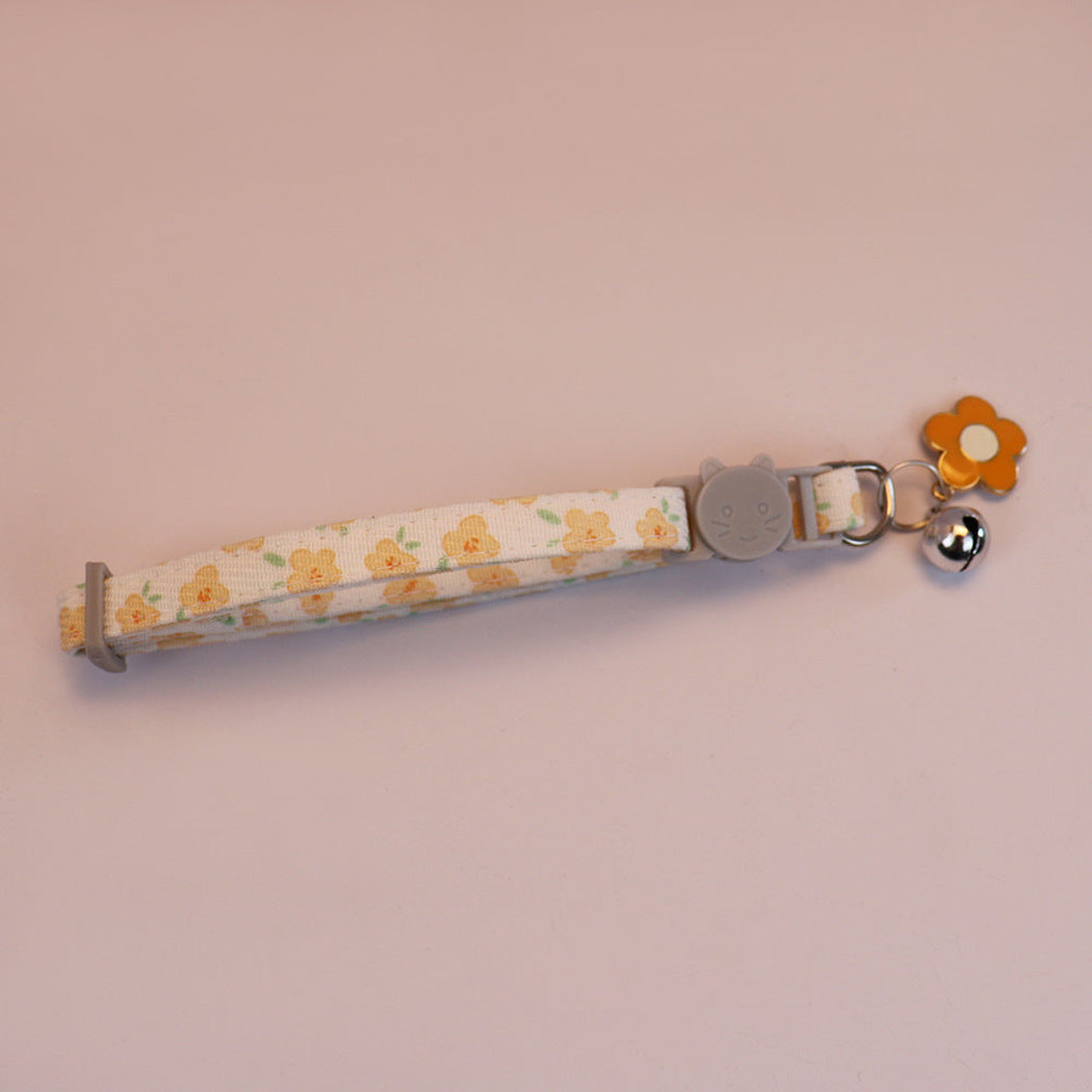 Yellow floral cat collar with cat-face buckle, bell and orange flower charm