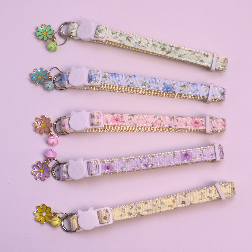 Five floral cat collars with color-coordinated bells and flower charms