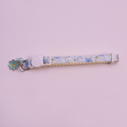 Light blue floral cat collar with bell and flower charm