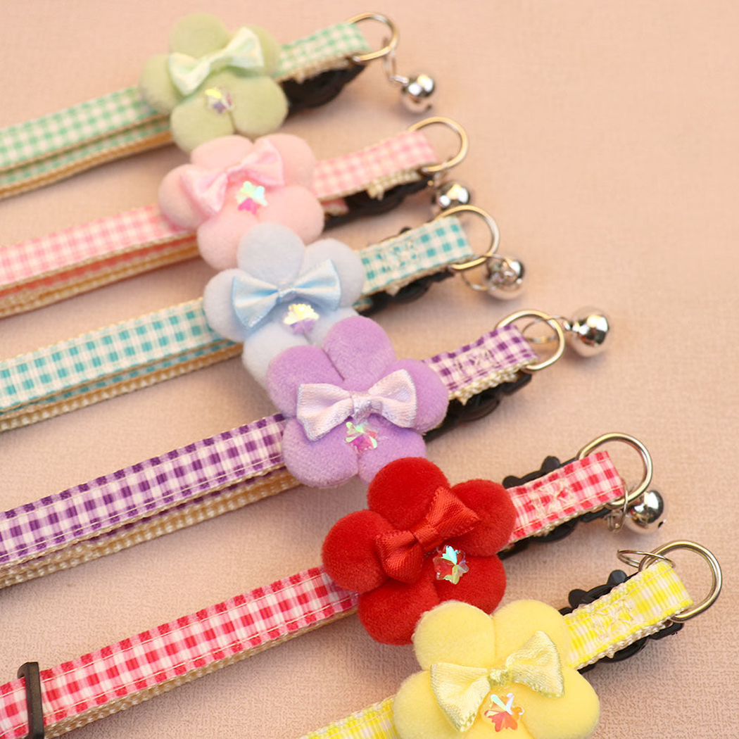 Close-up of fuzzy flower bows, gingham straps and silver-tone bells
