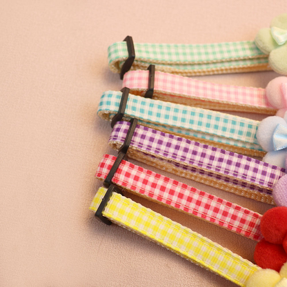 Close-up of gingham collar straps and adjustable sliders in six colors