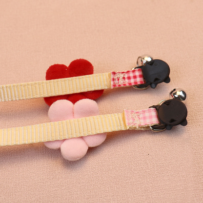 Reverse close-up of cream webbed straps and black cat-face buckles