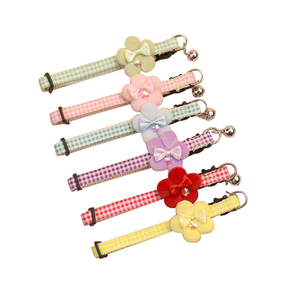 Six gingham flower cat collars displayed on a white background