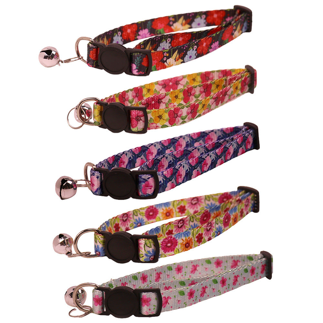 Five floral cat collars with bells displayed together