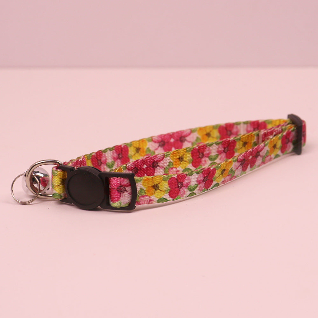 Pink and yellow floral cat collar with cat-face buckle and bell