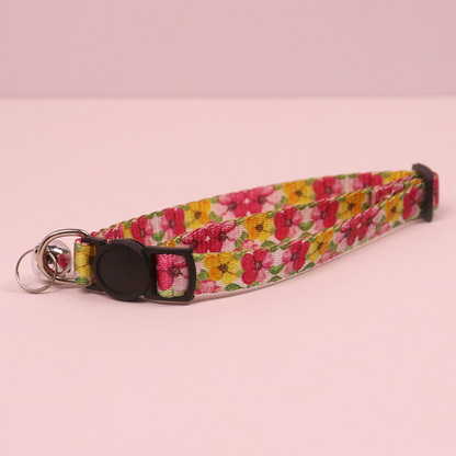 Pink and yellow floral cat collar with cat-face buckle and bell