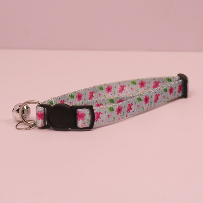 Light blue floral cat collar with cat-face buckle and bell