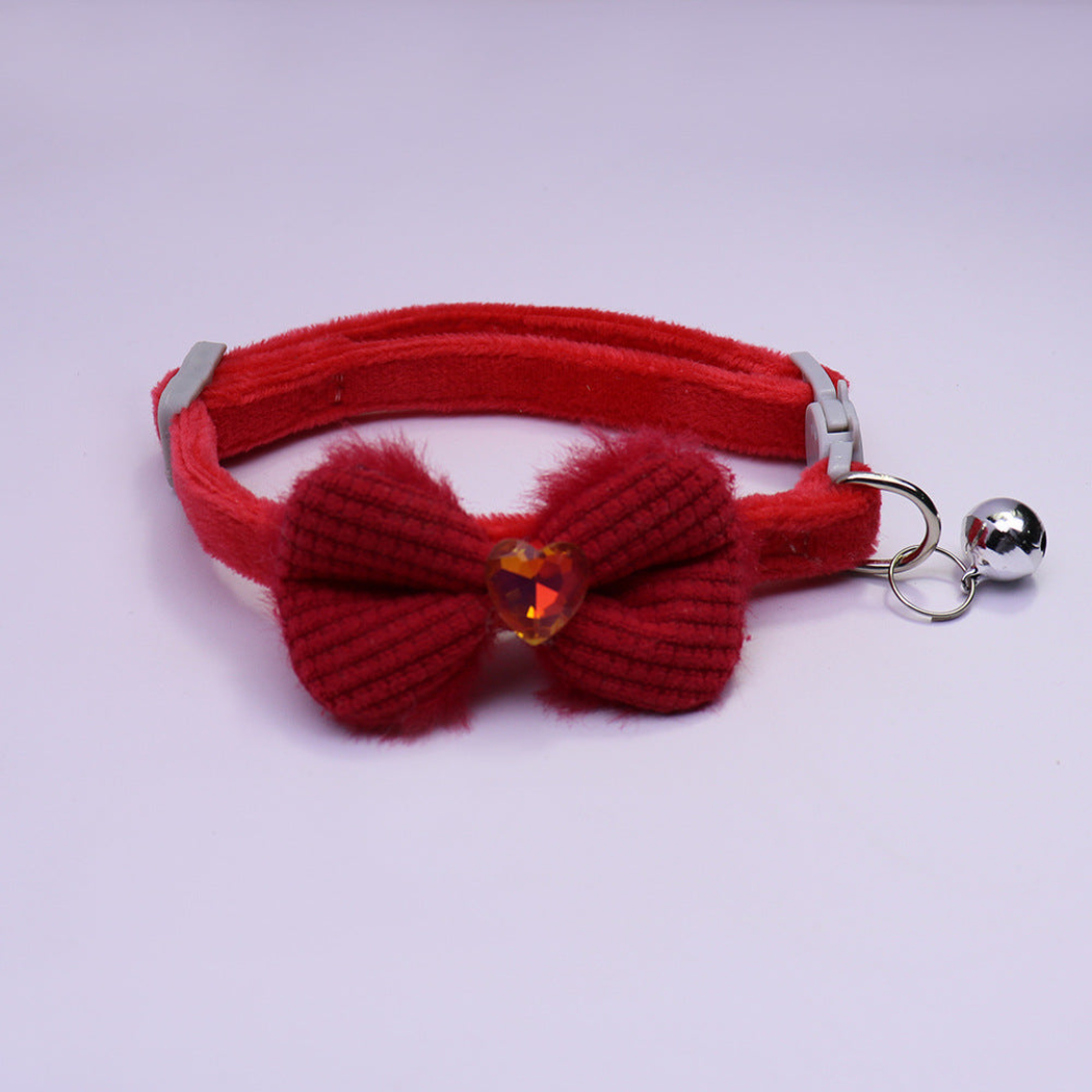 Red bow cat collar with heart accent and silver-tone bell