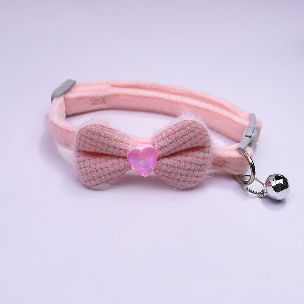 Light pink bow cat collar with heart accent and silver-tone bell