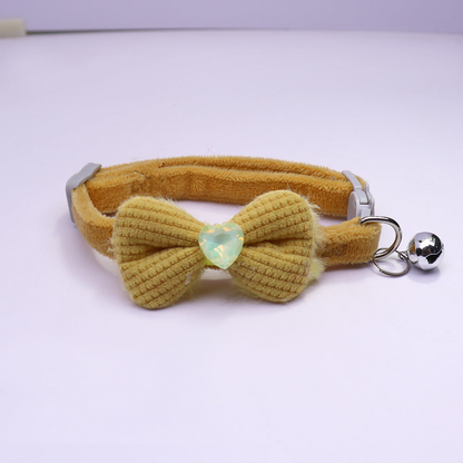 Mustard bow cat collar with heart accent and silver-tone bell