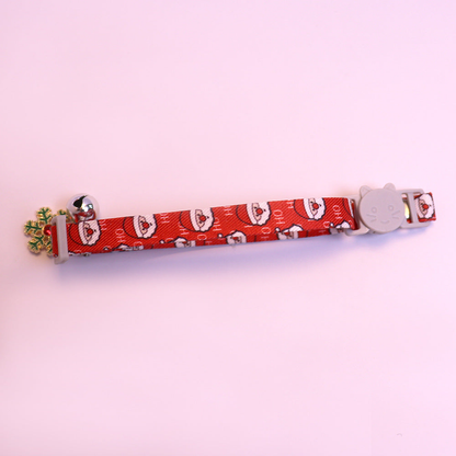 Red Santa-pattern cat collar with cat-face buckle, bell and snowflake charm