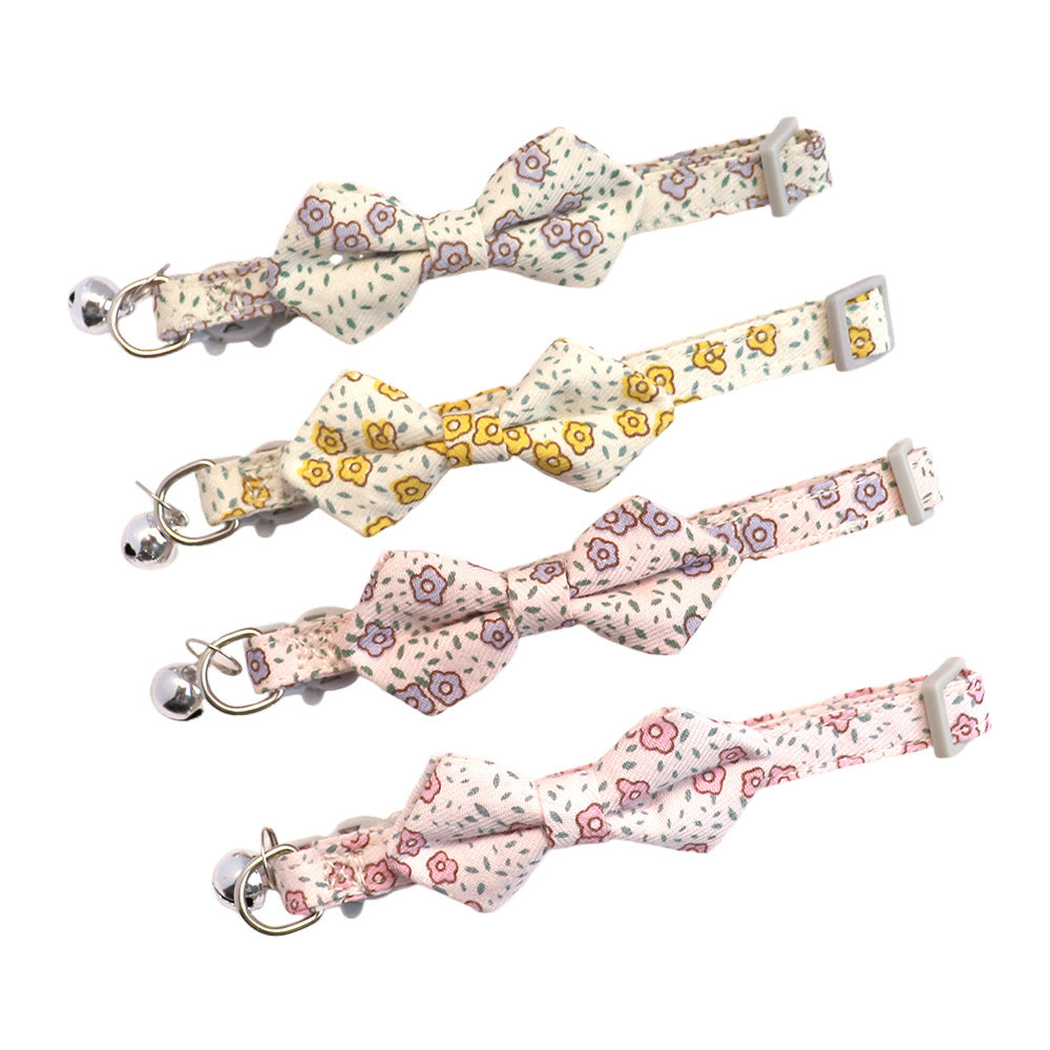 Four floral bow cat collars with silver-tone bells displayed together