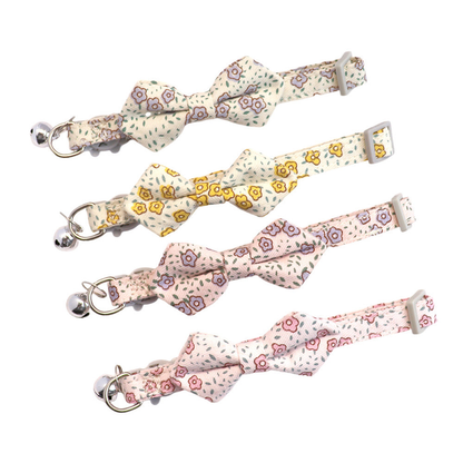 Four floral bow cat collars with silver-tone bells displayed together