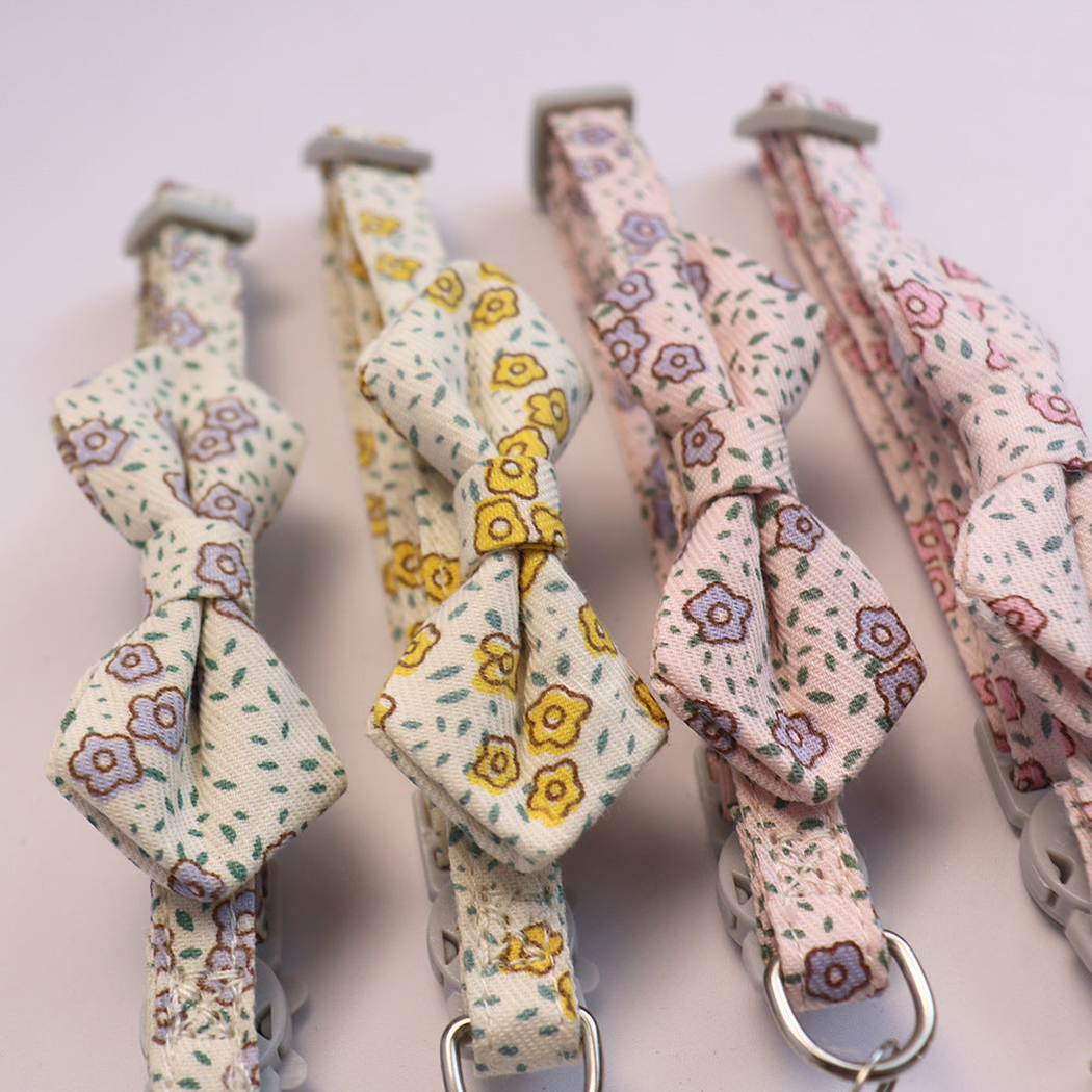 Close-up of four floral bow cat collars in coordinating colors