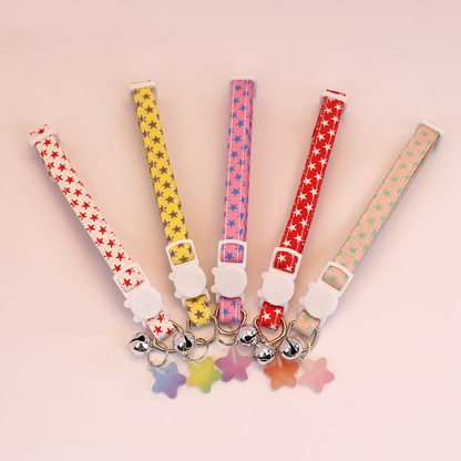 Five star-print cat collars with bells and star charms displayed together