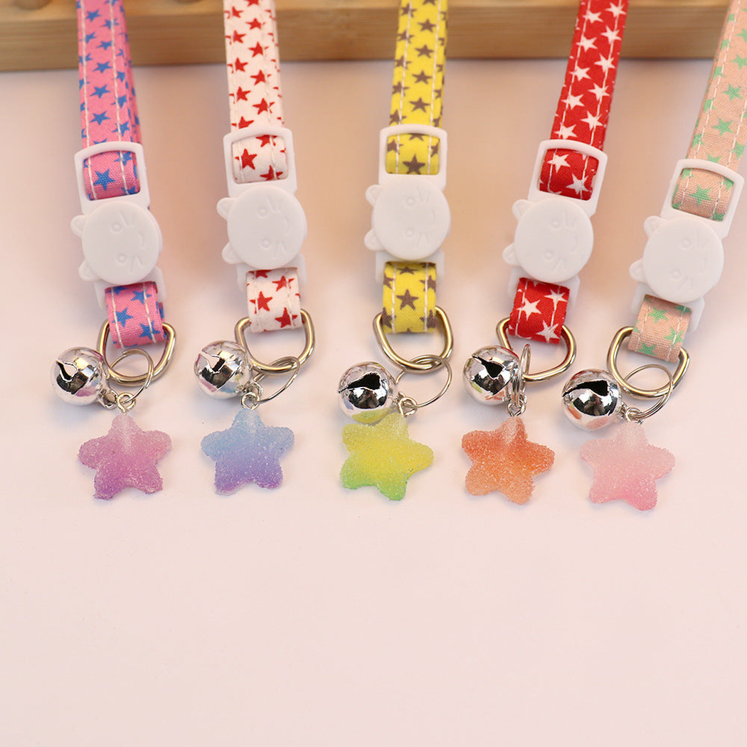 Close-up of cat-face buckles, bells and translucent star charms