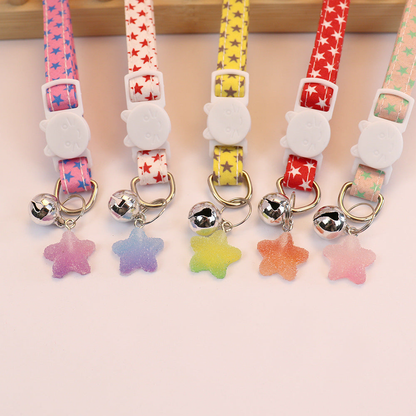 Close-up of cat-face buckles, bells and translucent star charms