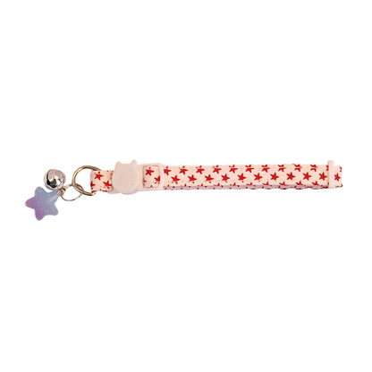 White cat collar with red stars, bell and blue-purple star charm