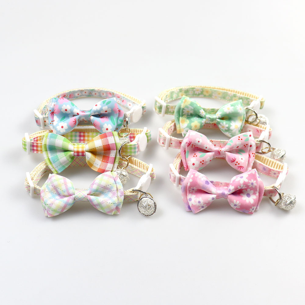 Six floral and plaid bow cat collars arranged in two rows