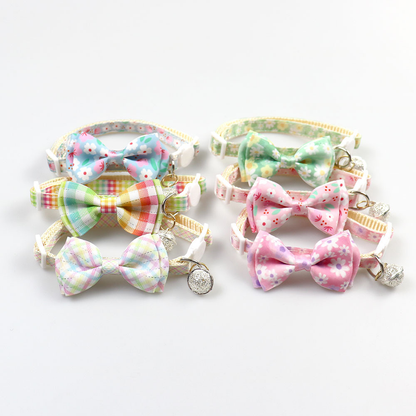 Six floral and plaid bow cat collars arranged in two rows