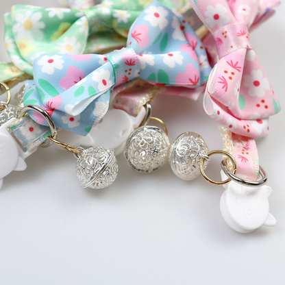 Close-up of floral openwork bells, attachment rings and cat-face buckles