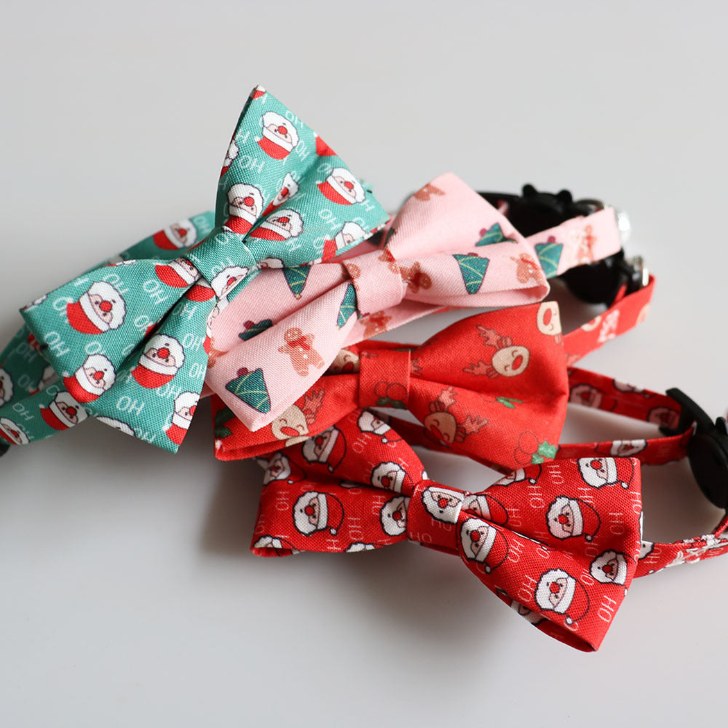 Close-up of four festive bow patterns on cat collars