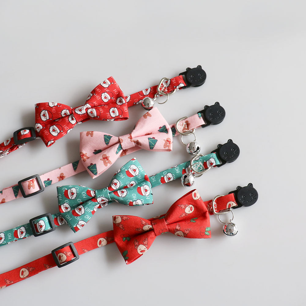Four festive bow cat collars showing bells, rings, buckles and adjustment sliders