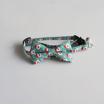 Teal Santa-pattern bow cat collar with bell