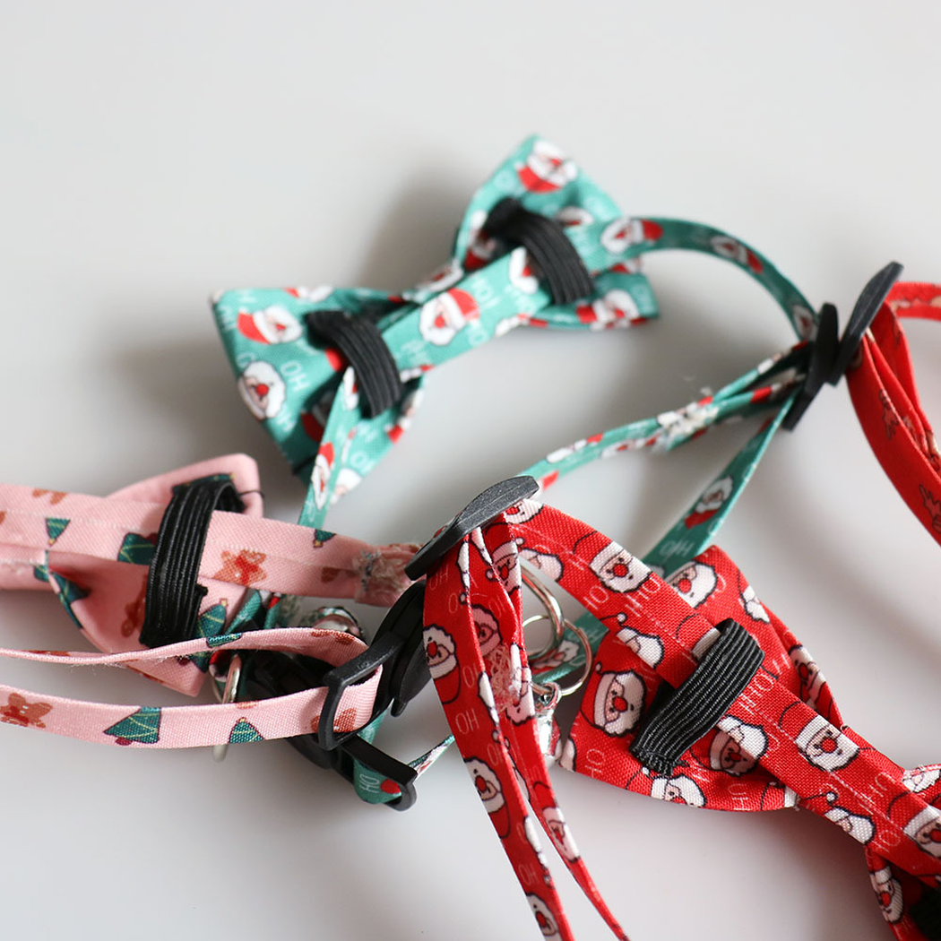 Close-up of elastic bow loops attached around printed cat collar straps