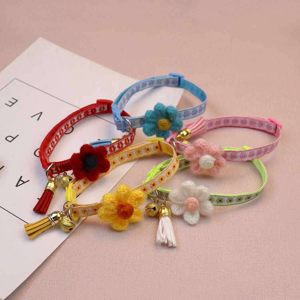 Five floral cat collars arranged together with flower accents, bells and tassels