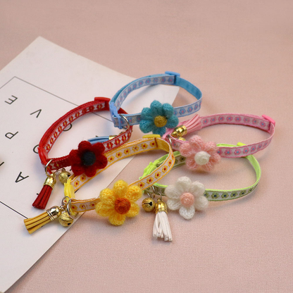 Five floral cat collars arranged together with flower accents, bells and tassels