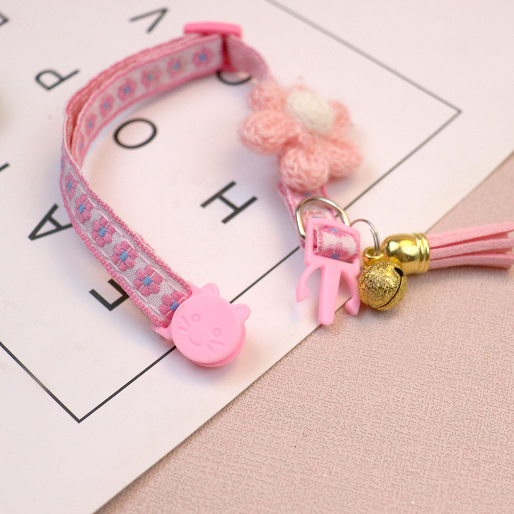 Close-up of the pink cat collar cat-face buckle, D-ring, bell and tassel