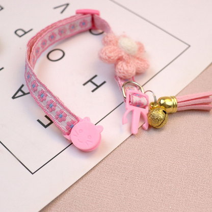 Close-up of the pink cat collar cat-face buckle, D-ring, bell and tassel