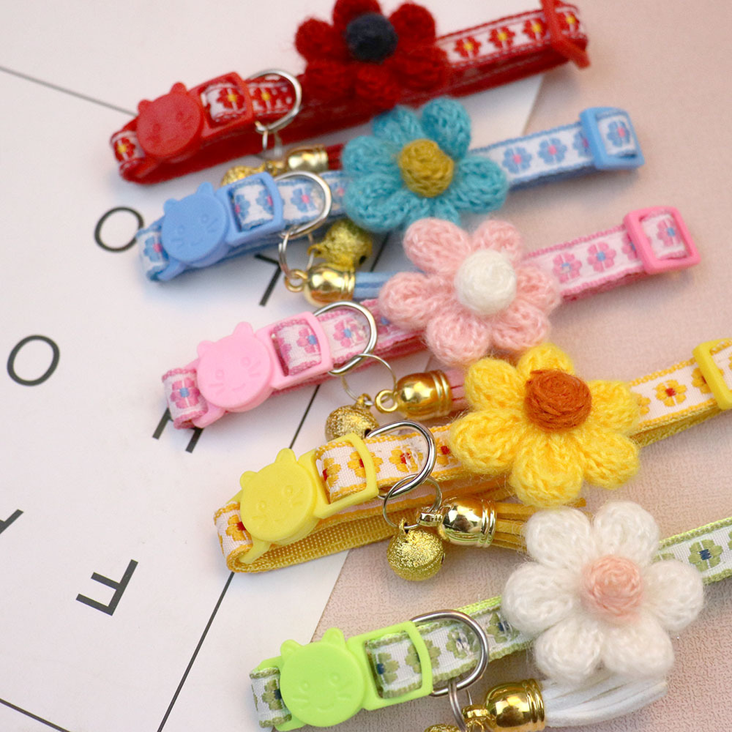 Close-up of floral collar bands, raised flower accents, buckles and bells