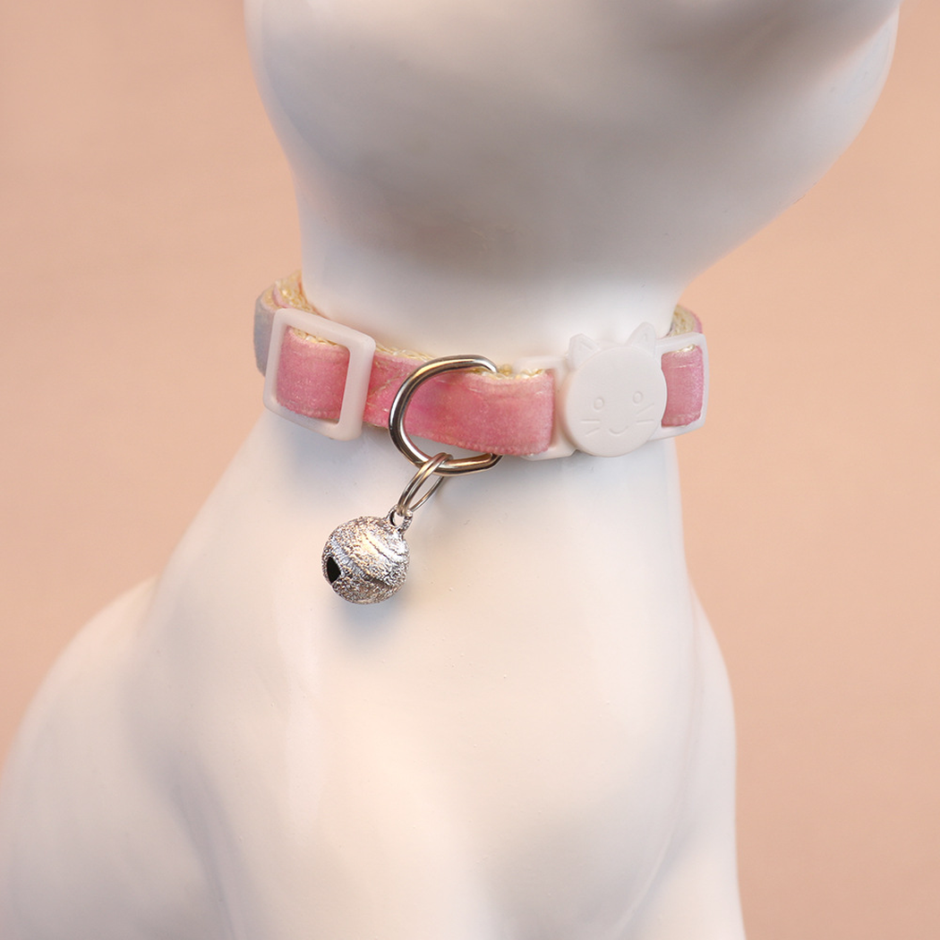 Pastel rainbow cat collar with bell displayed on a cat-shaped model