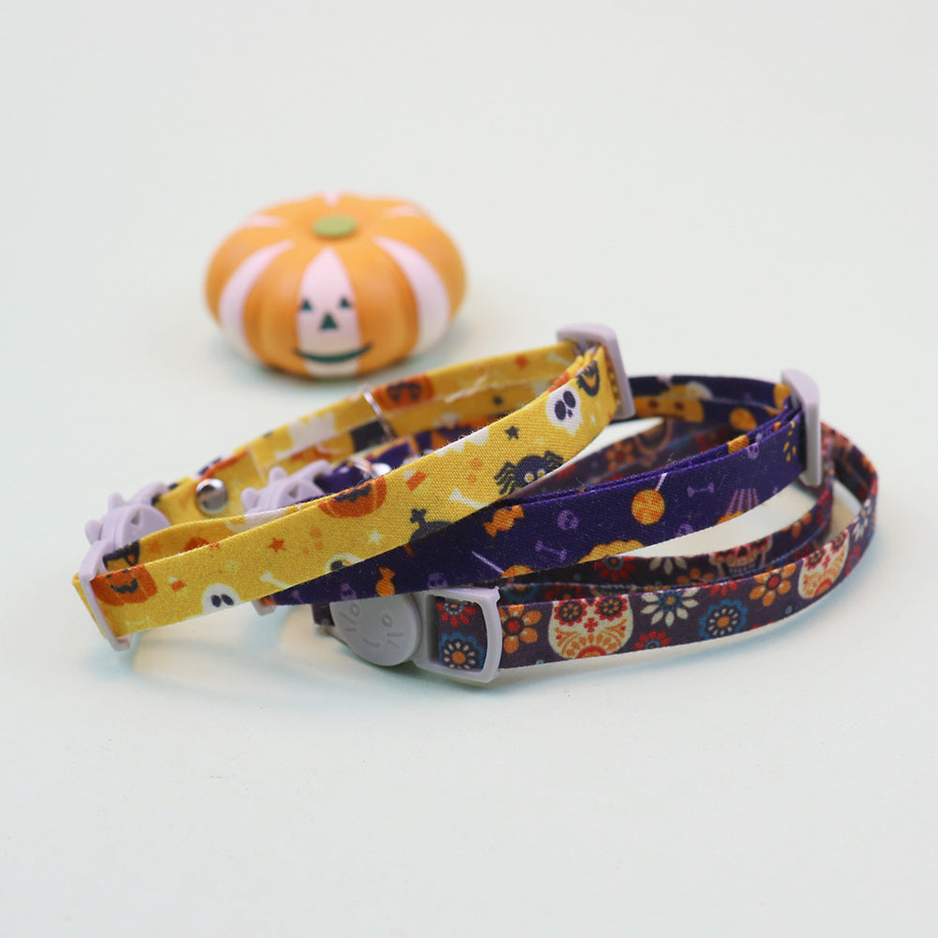 Yellow, purple and navy patterned cat collars arranged together