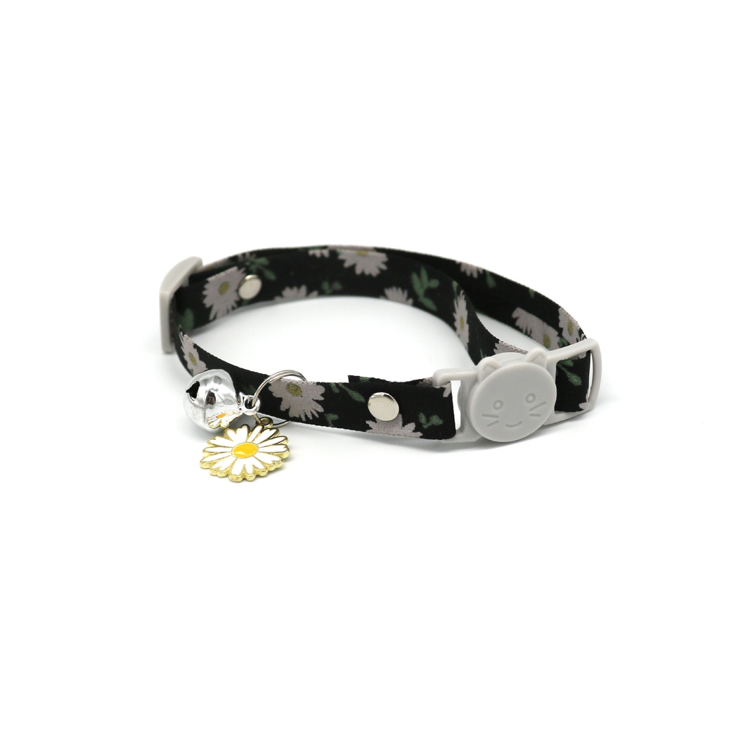 Black daisy-print cat collar with cat-face buckle, bell and flower charm
