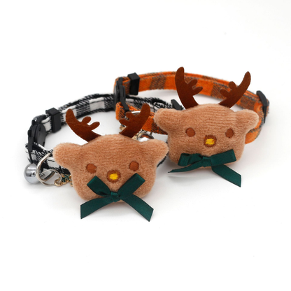 Orange and black-and-white plaid reindeer cat collars with bows, bells and snowflake charms