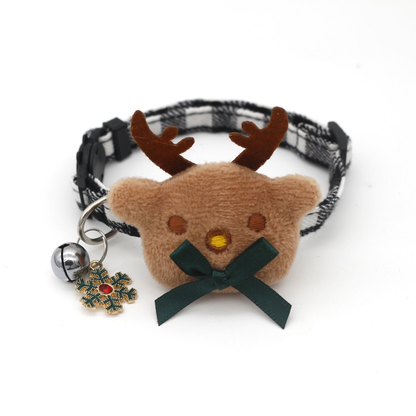 Black-and-white plaid reindeer cat collar with green bow, bell and snowflake charm