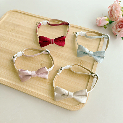 Red, light blue, blush pink, and ivory bow cat collars displayed together