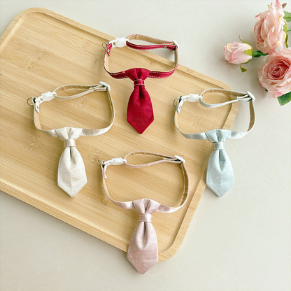 Red, ivory, light pink and light blue necktie cat collars displayed together
