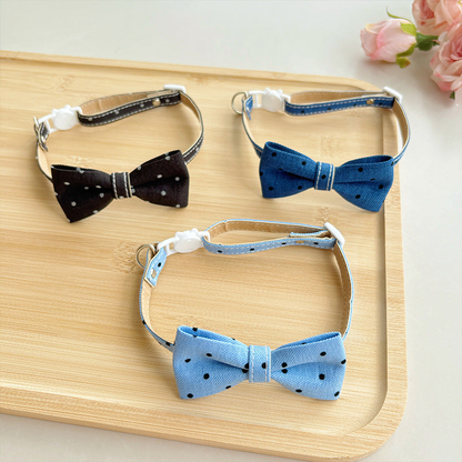 Light blue, navy and black polka-dot bow cat collars displayed together