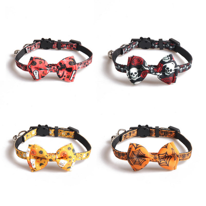 Four Halloween-print cat collars with bows and bells