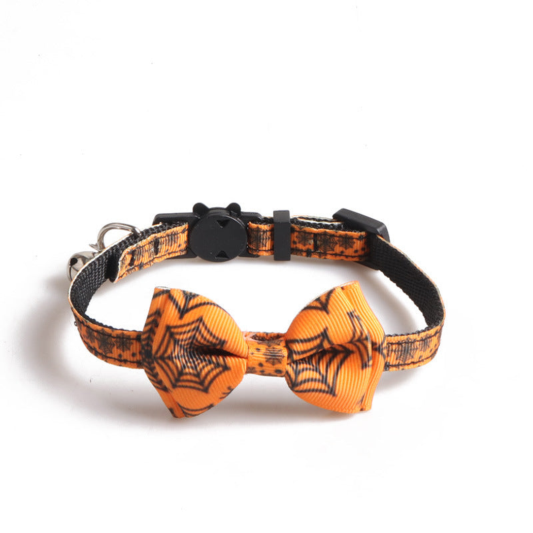 Orange cat collar with black spiderweb print, bow and bell