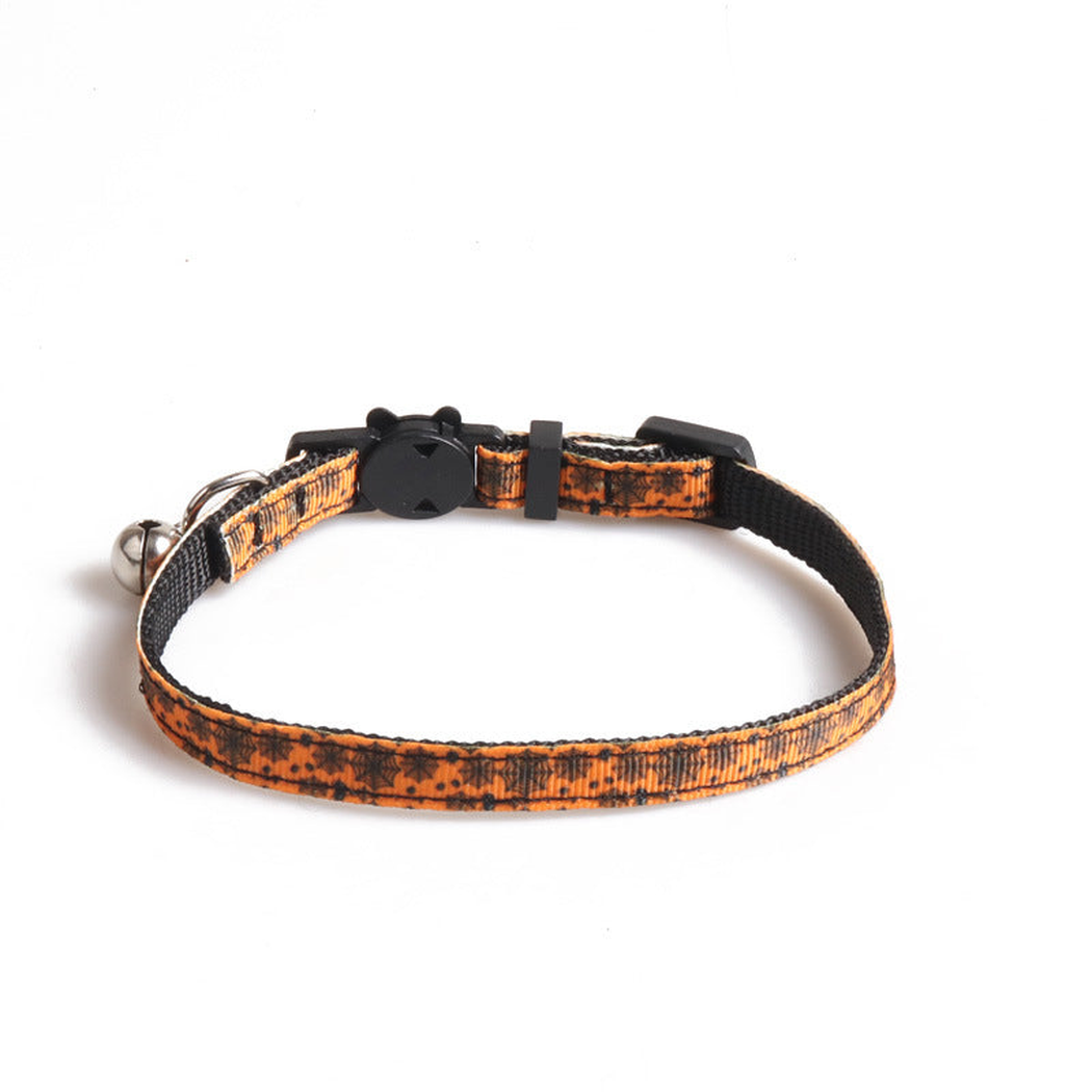 Orange cat collar with black spiderweb print, cat-face clasp and bell